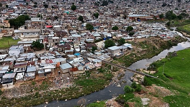 Volunteers help clean the polluted Jukskei River “prone” to flash floods