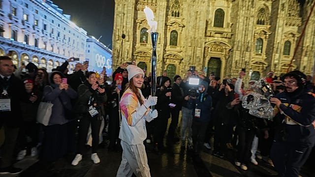 Winter Olympics flame lights up Milan as crowds pack Piazza Duomo