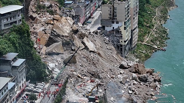 China rescuers race to find trapped people after landslide