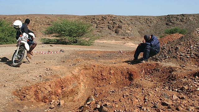 Women sand miners toil stripped Cape Verde beach